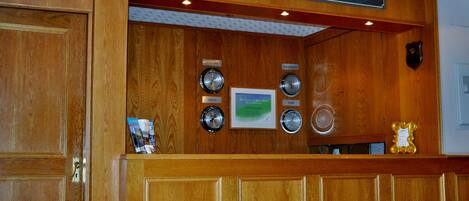 A wooden reception desk with a sign that reads "RECEPTION".