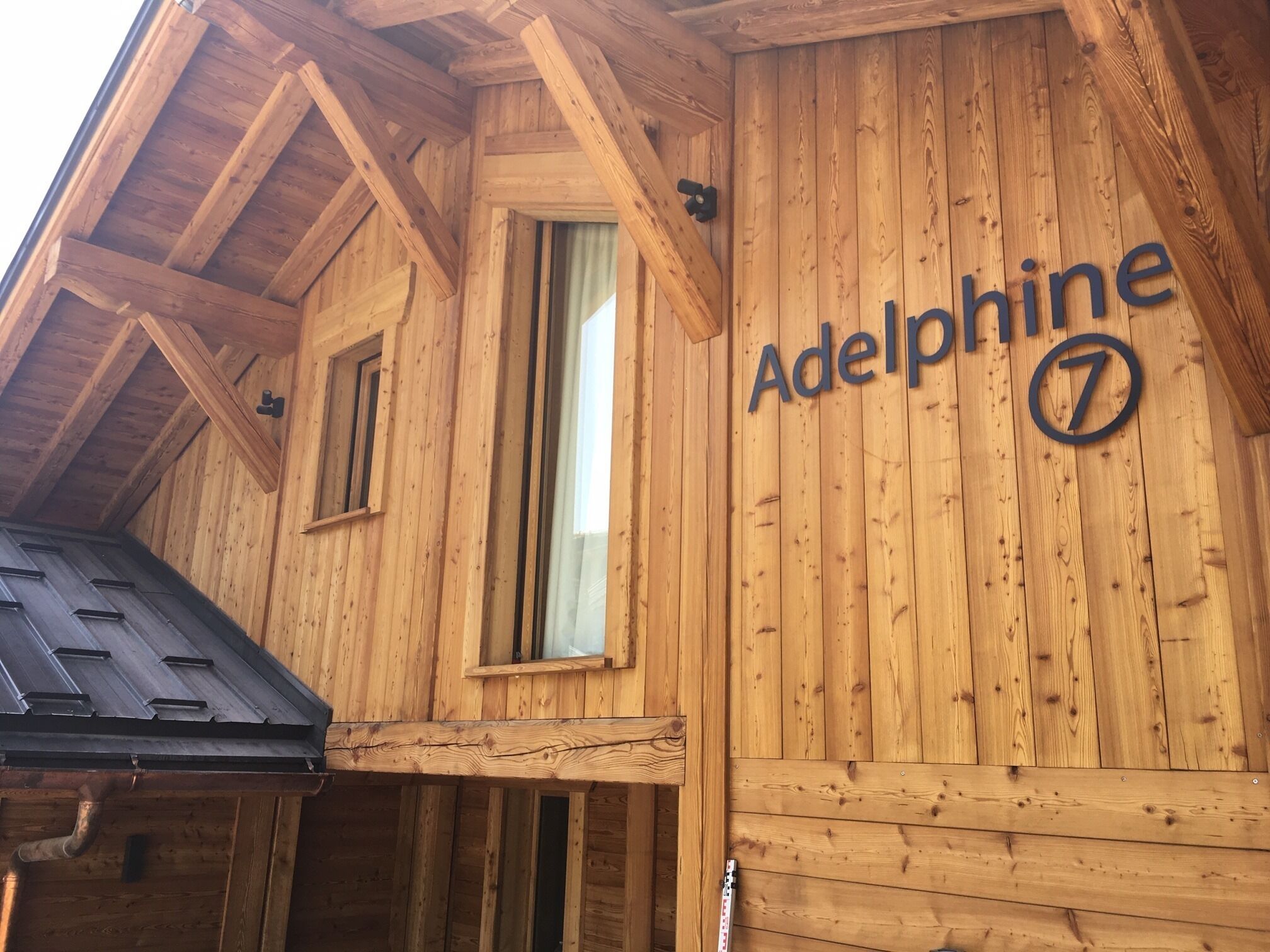 A wooden building with the name "Adelphine" and the number "7" on its facade.