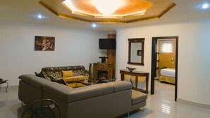 A living room with a sofa, a television, a fireplace, and a mirror. - Hotel Boutique Mary Carmen (Ambato)