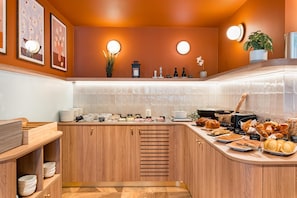 A kitchen with a wooden countertop, a sink, and various food items.