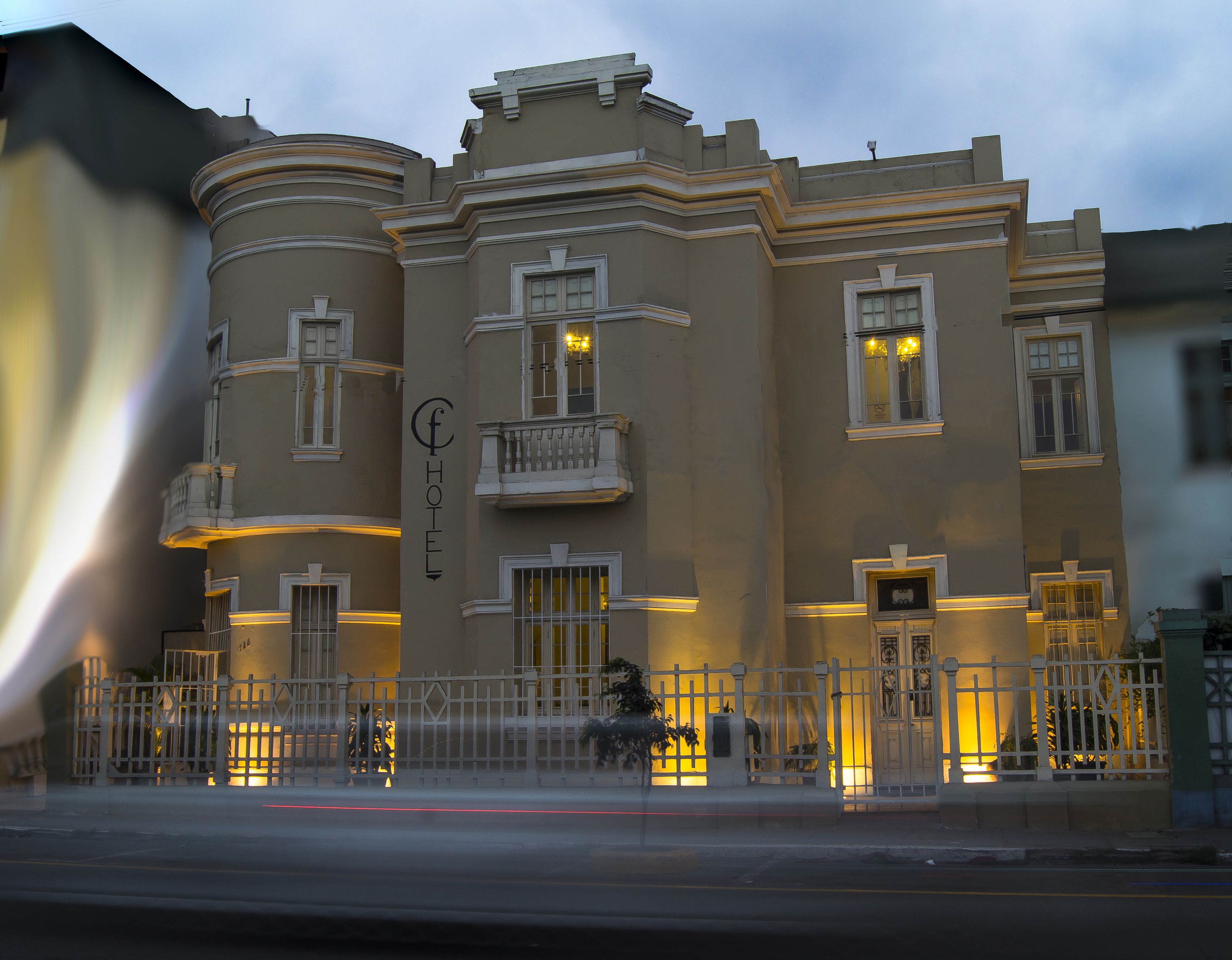 A historic hotel with a classic facade, multiple balconies, and a prominent entrance.