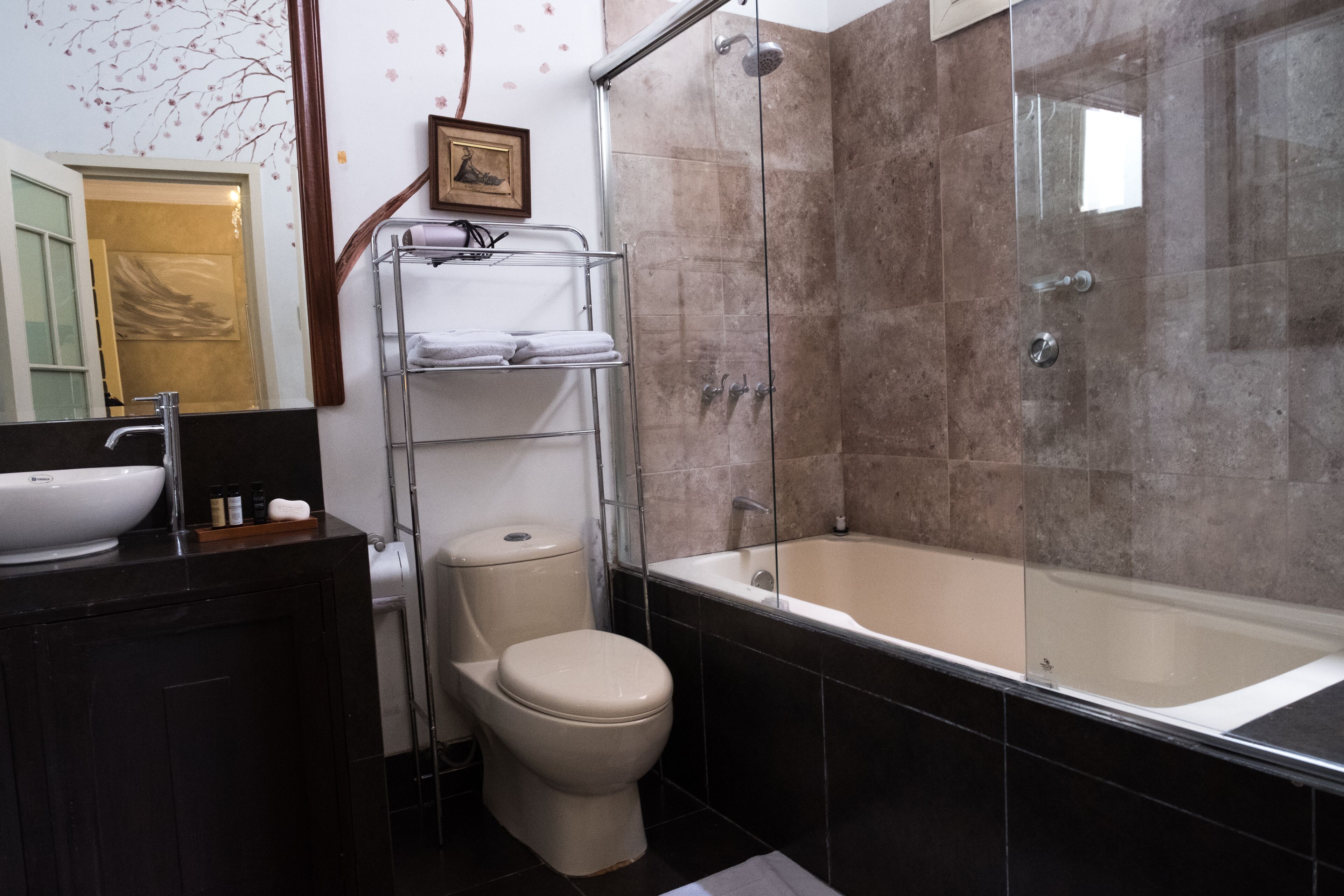 A bathroom with a bathtub, toilet, and sink.