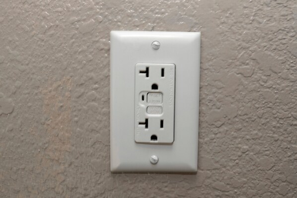 A standard electrical outlet on a textured wall. - Red Roof Inn PLUS+ Huntsville (Huntsville)