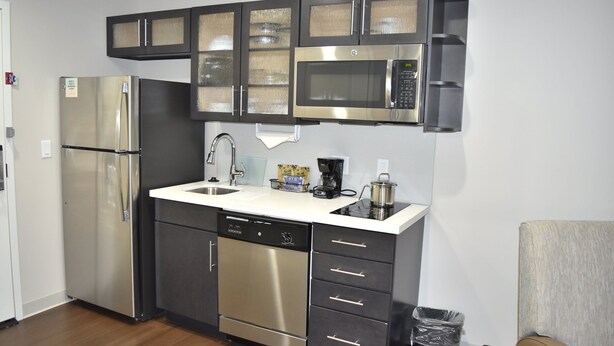 A modern kitchen with stainless steel appliances, a dishwasher, and a microwave.