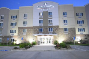 A hotel with a stone facade, multiple windows, and a sign indicating it is Candlewood Suites. - Candlewood Suites Kansas City - Independence by IHG (Independence)