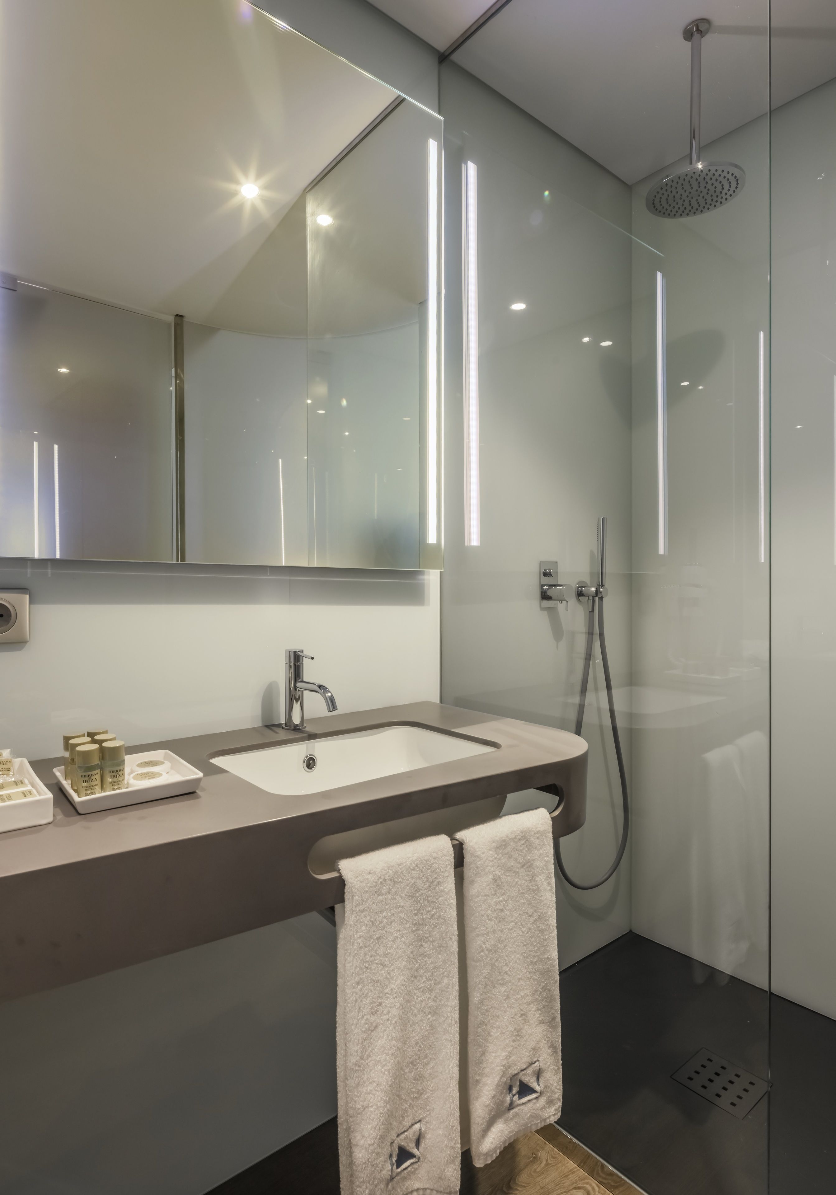 rainfall showerhead, eco-friendly toiletries, hair dryer, towels