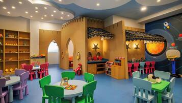 Children can play and learn in this imaginative space with tables, toys, and books.