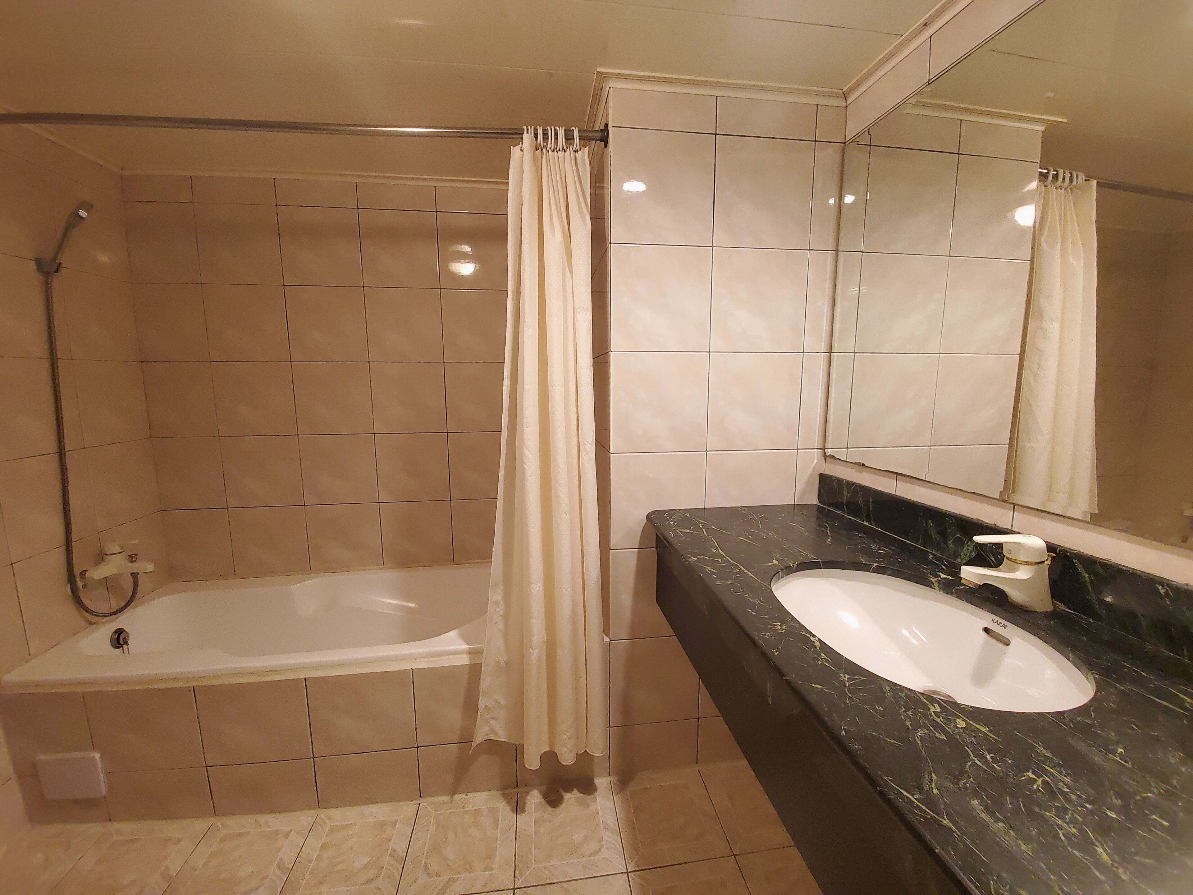 A bathroom with a bathtub, a sink, and a shower.