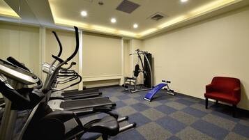A gym with treadmills, a stationary bike, and a weight machine.
