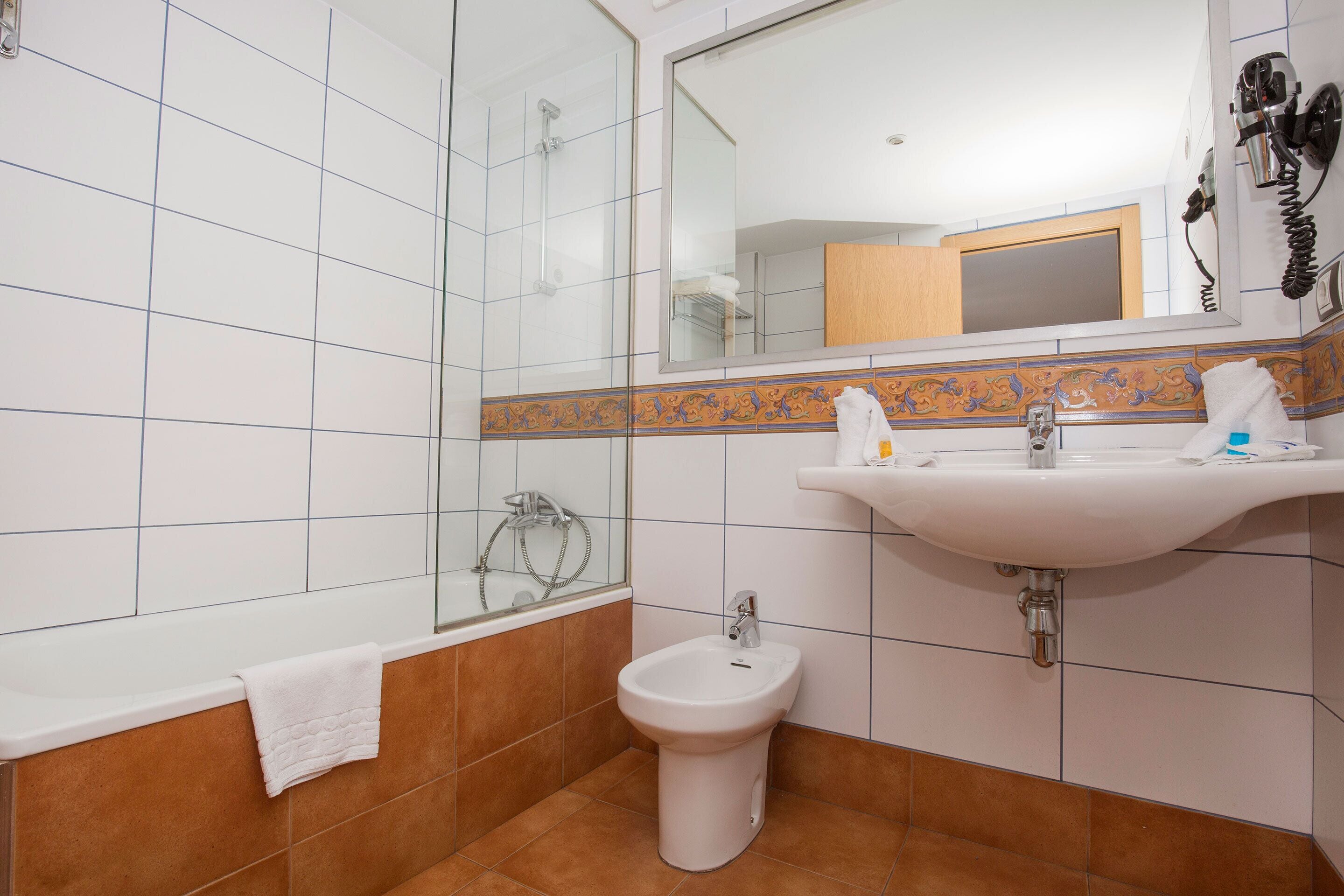 deep-soaking bathtub, hair dryer, towels, soap