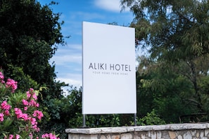 A sign for Aliki Hotel with the tagline 'Your home from home.' - Aliki Hotel (Lefkada)