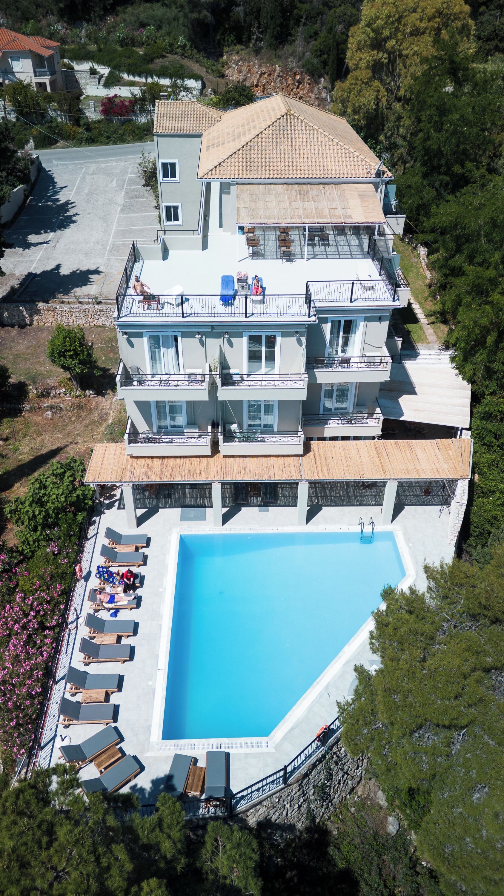 Un immeuble à plusieurs étages doté d’une piscine, de balcons et offrant une vue sur le paysage environnant.