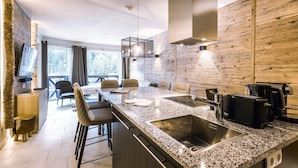 A modern kitchen with granite countertops, stainless steel appliances, and a large island with seating.