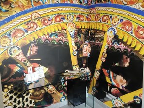 A colorful mural with intricate patterns and a central figure.