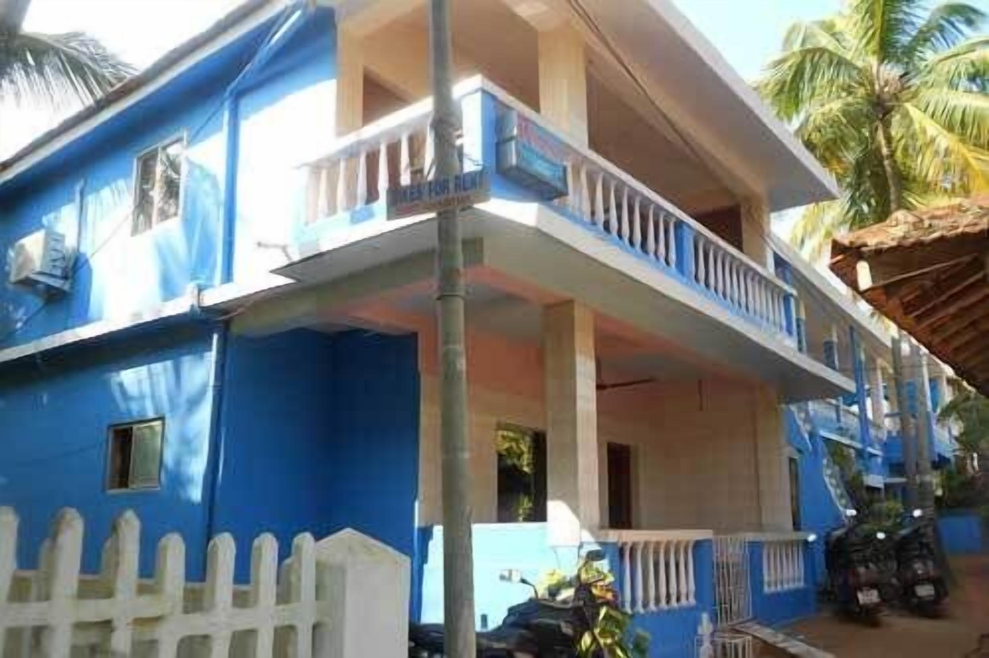 A two-story building with a balcony on the upper floor.