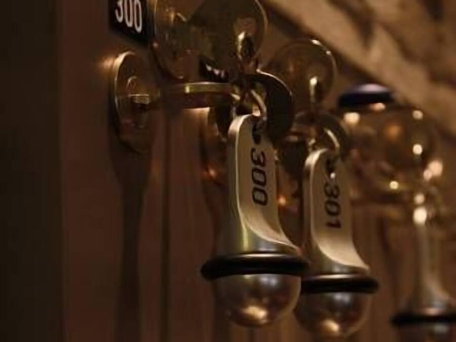 A row of hotel room keys with numbers 300, 301, and 205 visible.