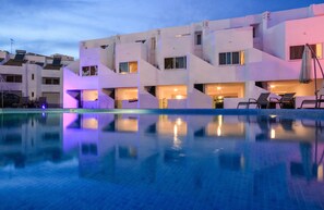 A modern hotel with a pool, multiple balconies, and outdoor seating areas. - Lagoa Hotel (Lagoa)
