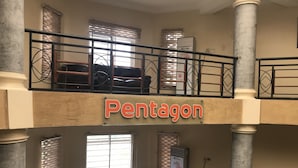 A multi-level interior with a sign reading "Pentagon". - Pentagon Luxury Suites Enugu (Enugu)