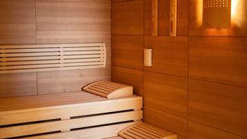 Een sauna met houten banken en een bank met voetsteun.