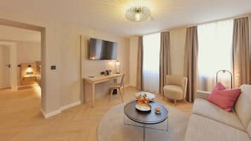 Superior Suite, 1 King Bed, Non Smoking, Refrigerator | Living area | Flat-screen TV, books