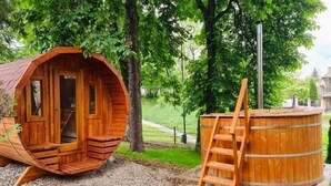 A wooden cabin with a spiral staircase and a wooden hot tub. - Hotel Park Sfantu Gheorghe (Sfantu Gheorghe (Transylvania))