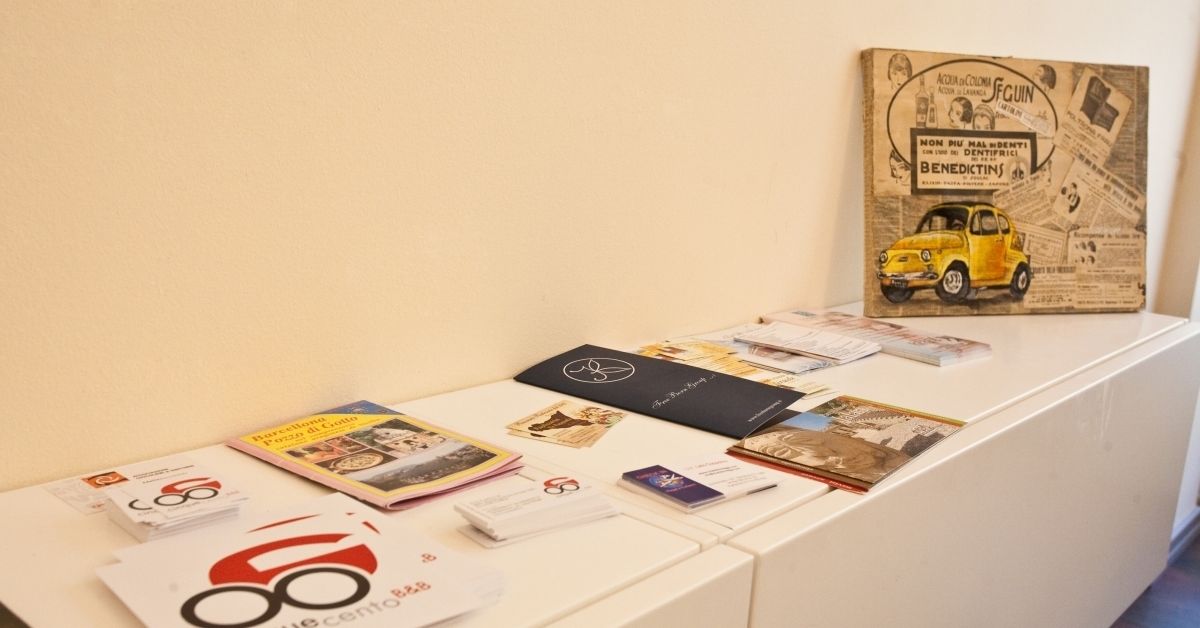 A display table with various items including books, pamphlets, and a framed picture.