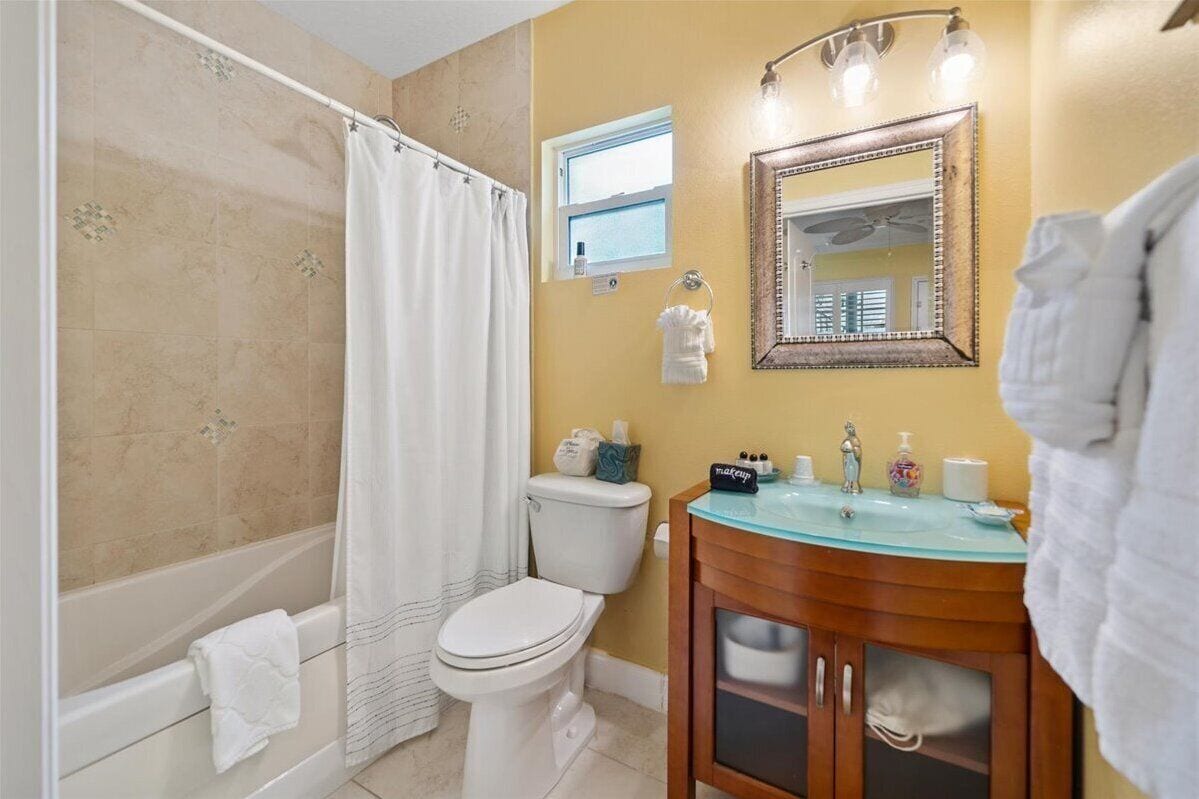 A bathroom with a bathtub, toilet, and sink.