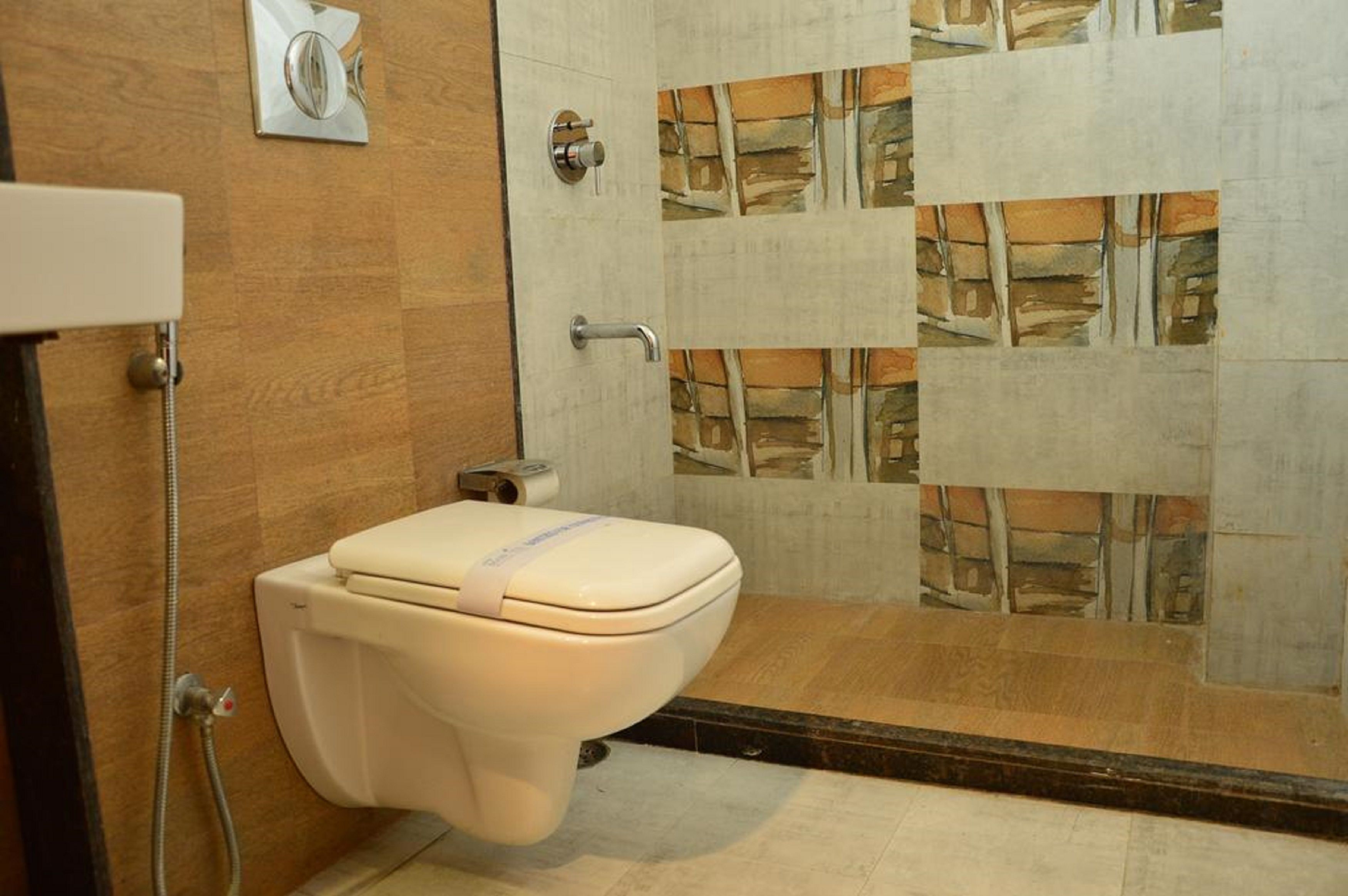 A bathroom with a toilet, shower, and tiled walls.