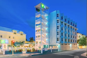 A multi-story hotel with a prominent tower, a visible staircase, and a sign indicating it's a Holiday Inn Express & Suites. - Holiday Inn Express & Suites Nassau by IHG (Nassau)