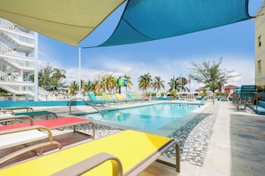 A hotel pool area with multiple lounge chairs and a clear blue sky. - Holiday Inn Express & Suites Nassau by IHG (Nassau)