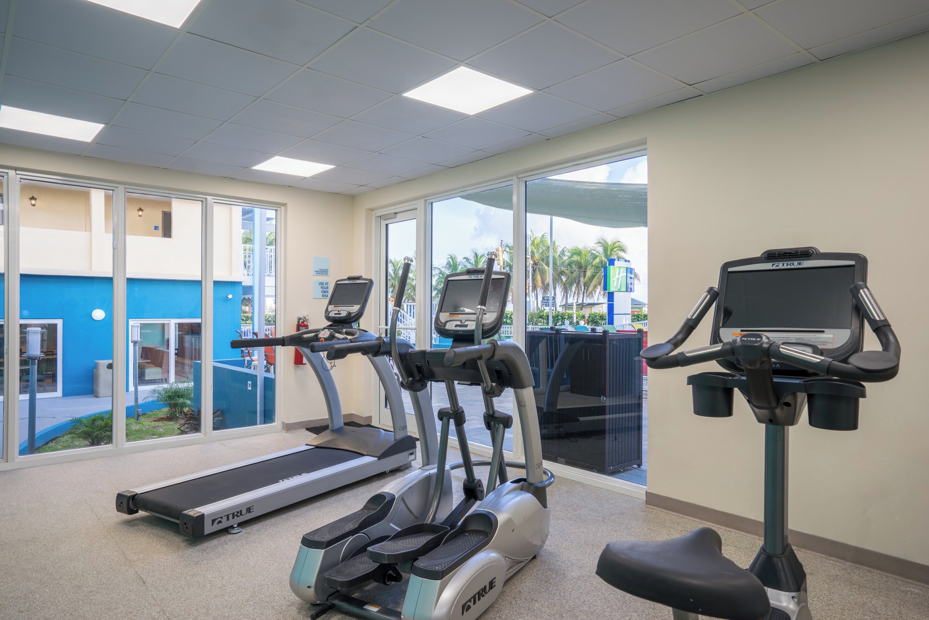 A fitness center with treadmills, ellipticals, and a stationary bike.