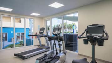 A fitness center with treadmills, ellipticals, and a stationary bike.