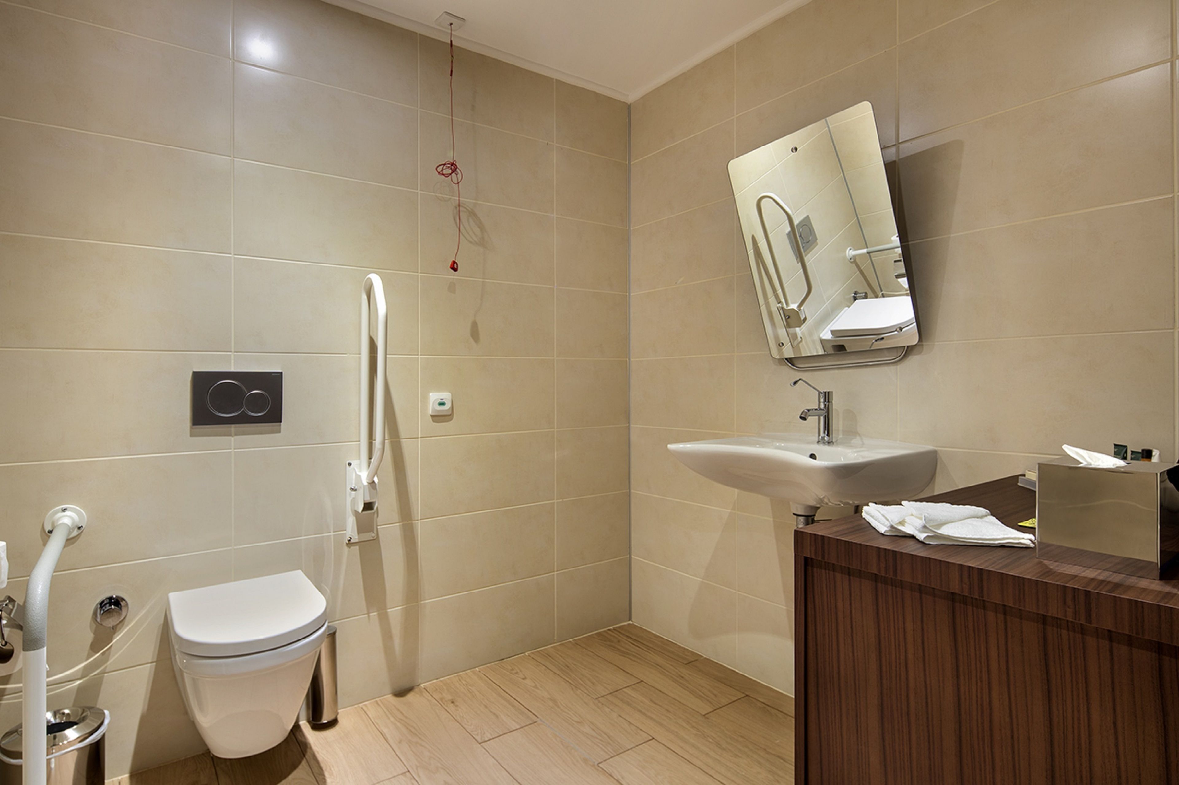 A bathroom with a toilet, a sink, and a shower.