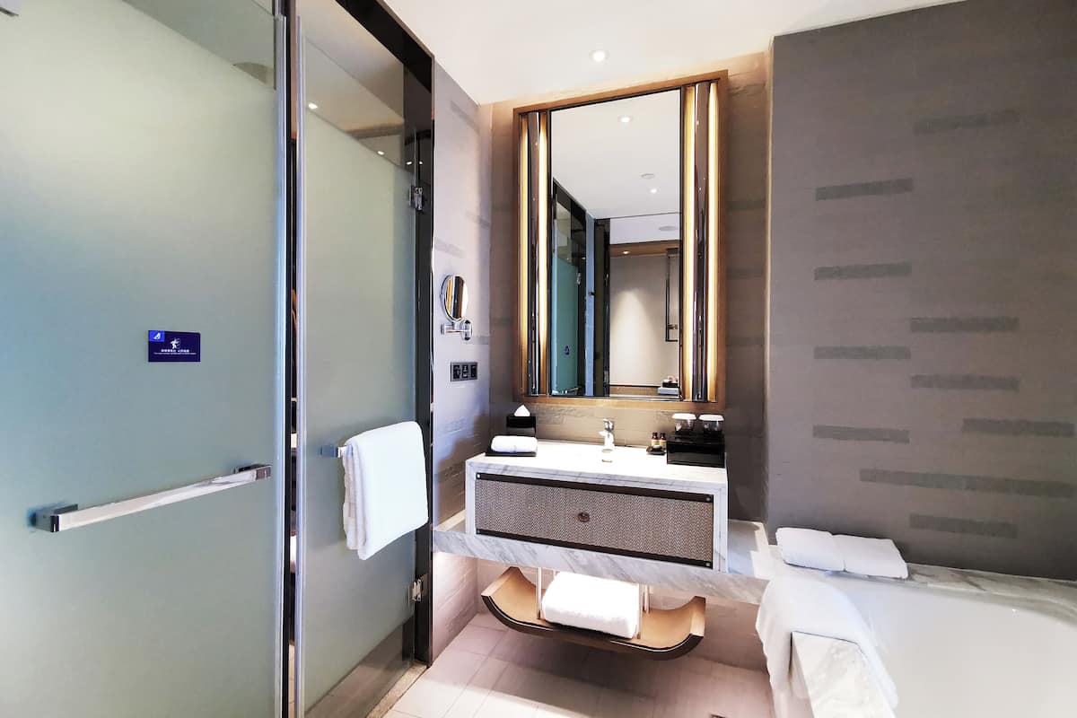 deluxe twin room   | bathroom | separate bathtub and shower, rainfall showerhead, designer toiletries
