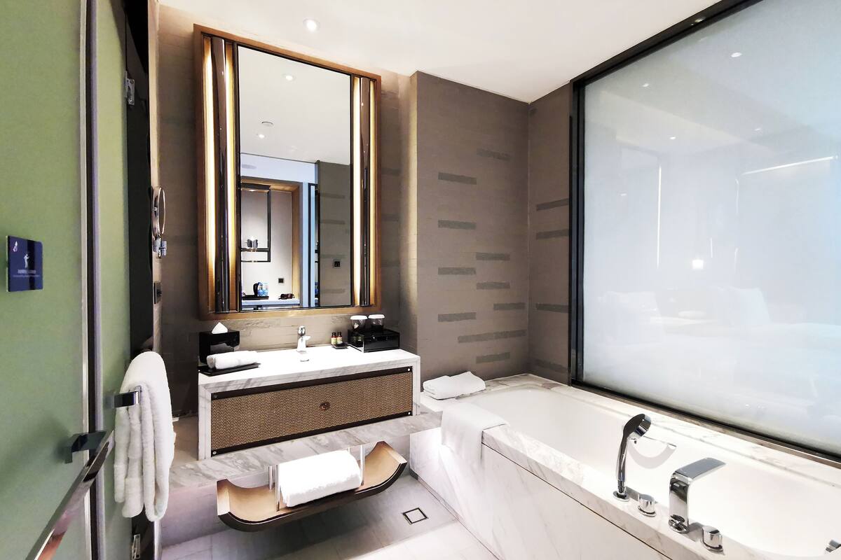 separate bathtub and shower, rainfall showerhead, designer toiletries