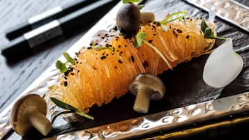 A dish with a variety of ingredients including mushrooms, herbs, and possibly some type of vegetable or fruit.