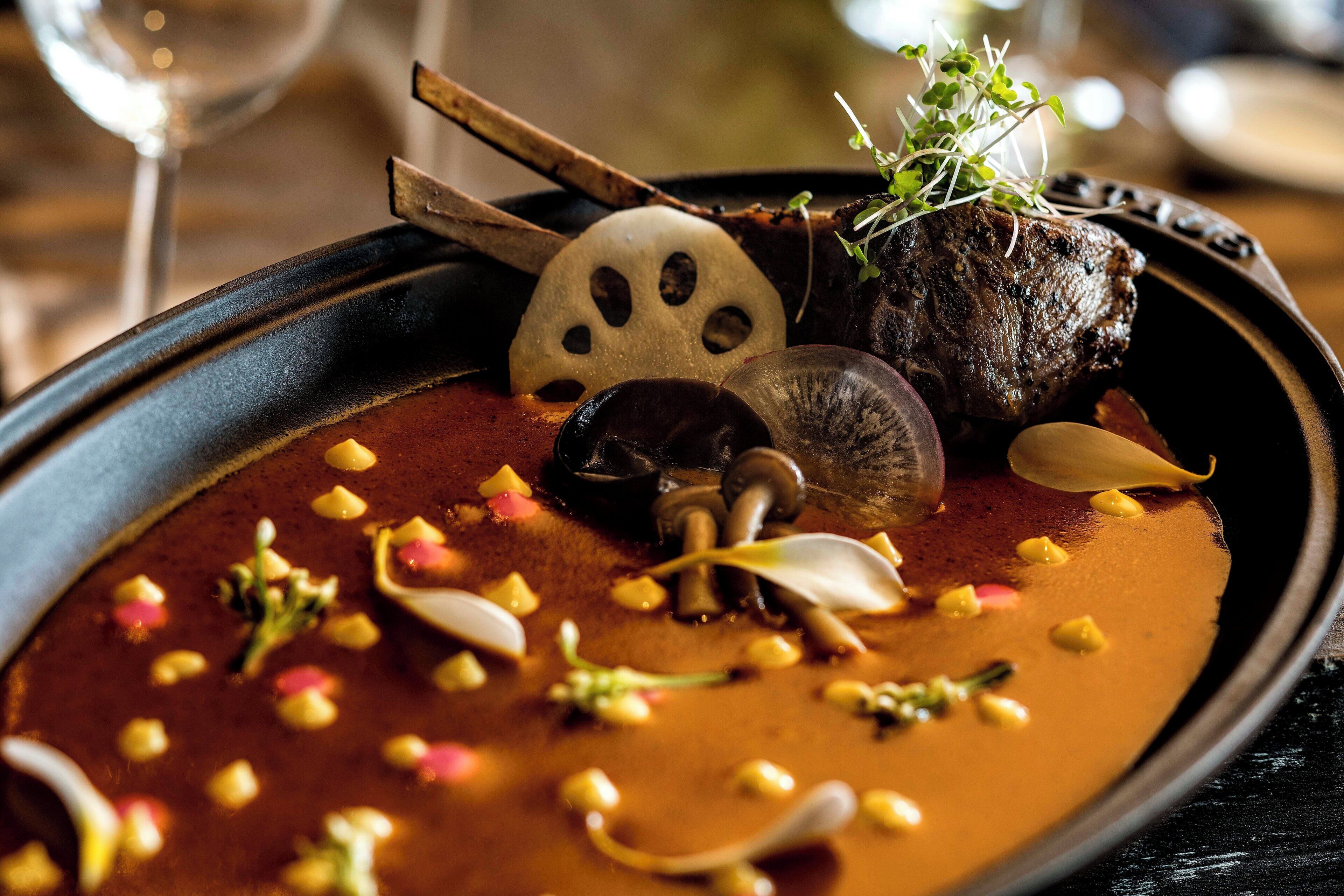A plate of food with a variety of garnishes and a piece of meat.
