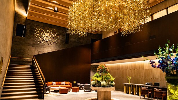 A modern lobby with a staircase, seating area, and a central decorative piece. - InterContinental Chennai Mahabalipuram Resort by IHG (Tirupporur)