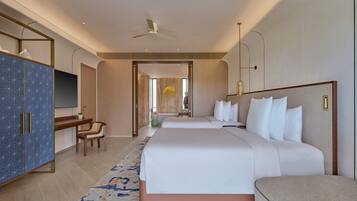 A modern hotel room with a large bed, a desk, a wardrobe, and a television.