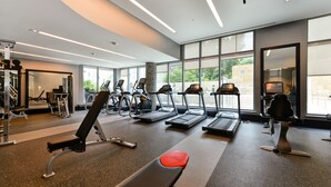A gym with treadmills, a bench, and weight machines.