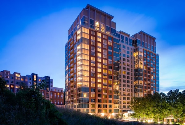 A multi-story hotel with a modern architectural design, featuring balconies and large windows.