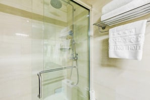 A glass-enclosed shower with a handheld showerhead and a handheld faucet. - Zouping Hotel (Binzhou)