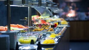 A buffet with various food items and utensils. - Novotel Marsa Alam Beach Resort (El Quseir)