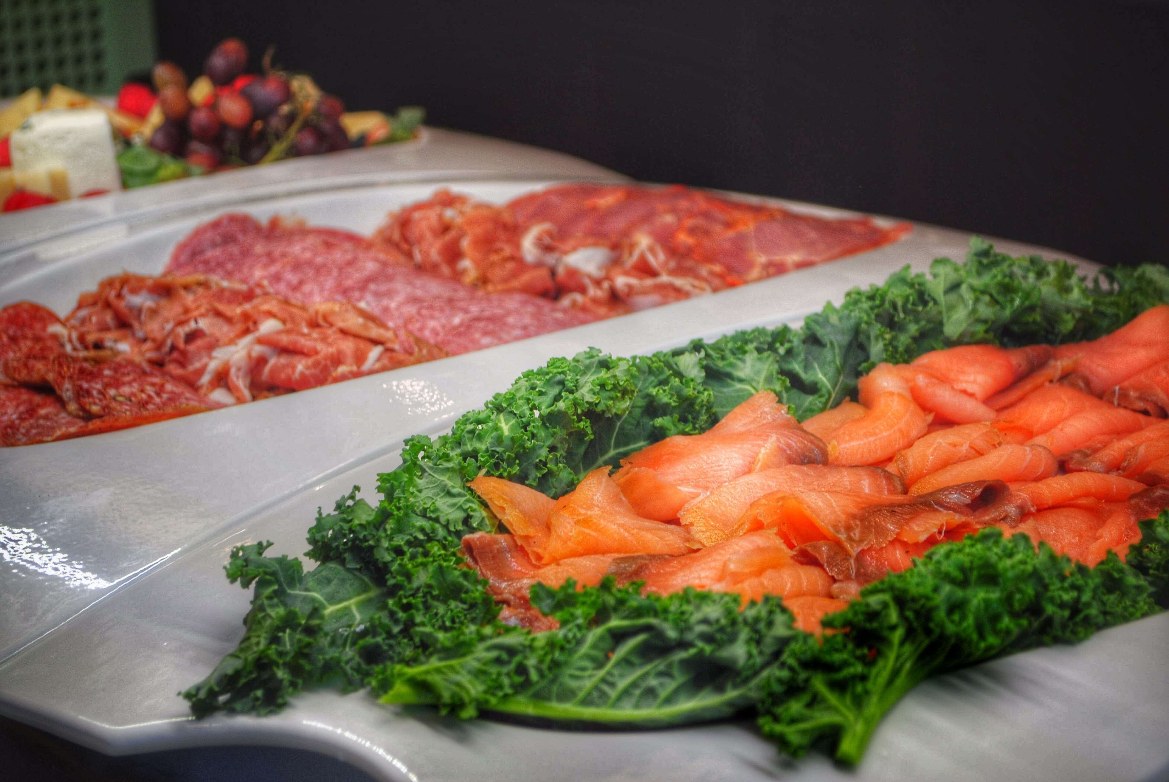 A buffet with various meats and vegetables.