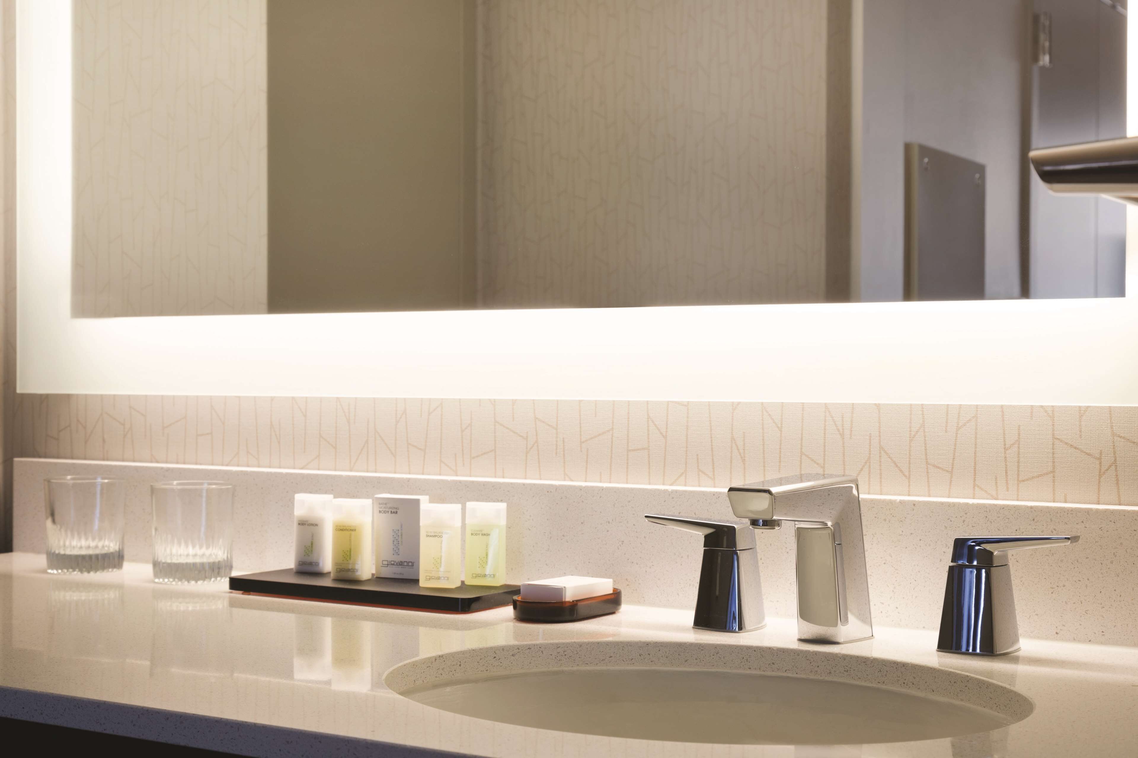 suite, 2 queen beds, corner | bathroom | free toiletries, hair dryer, towels