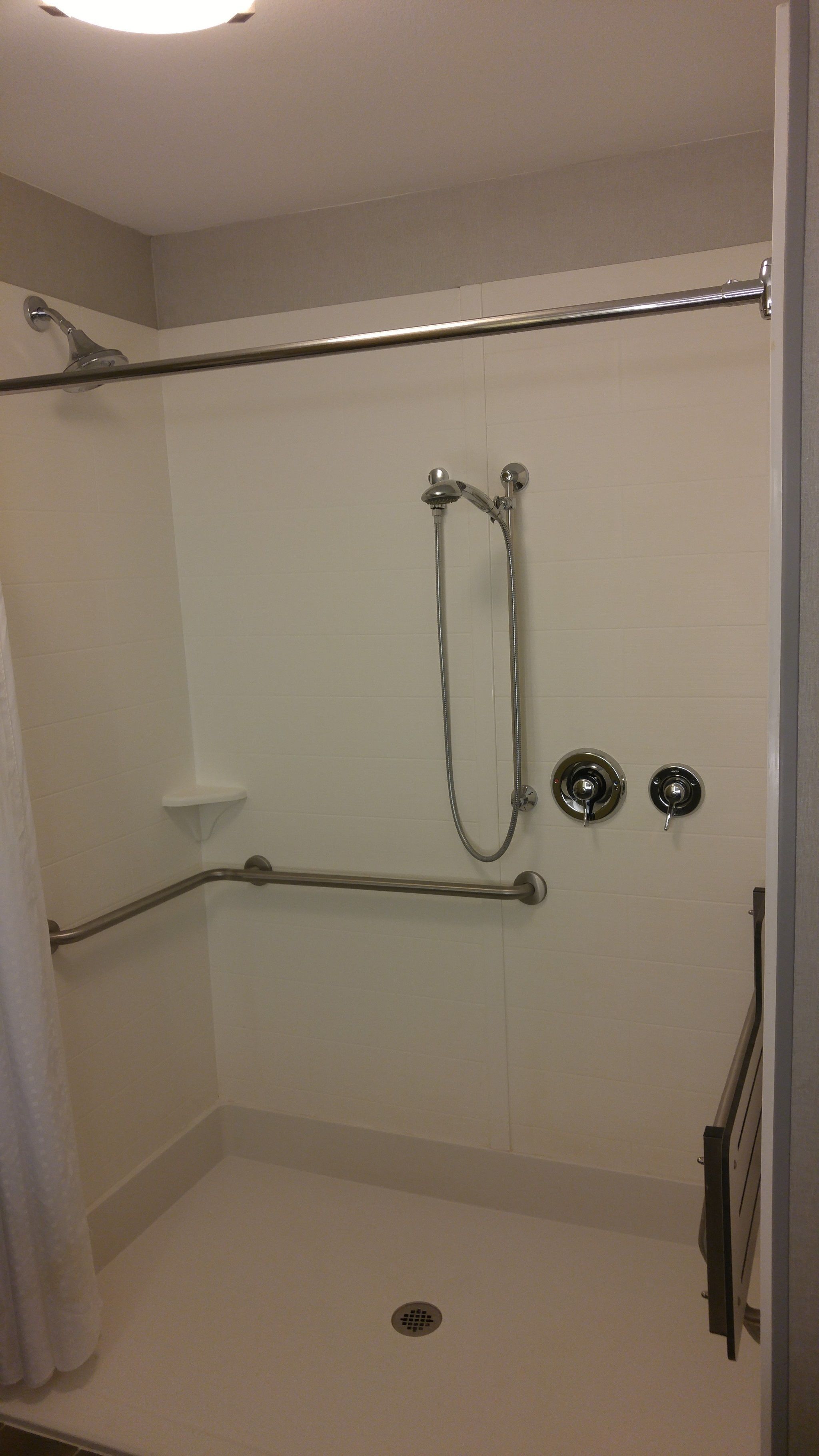 ada accessible room, 1 king bed, accessible, non smoking (roll-in shower) | bathroom | combined shower/bathtub, free toiletries, hair dryer, towels