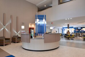 A hotel lobby with a reception desk, seating area, and a staircase. - Holiday Inn Express & Suites Shippensburg by IHG (Shippensburg)