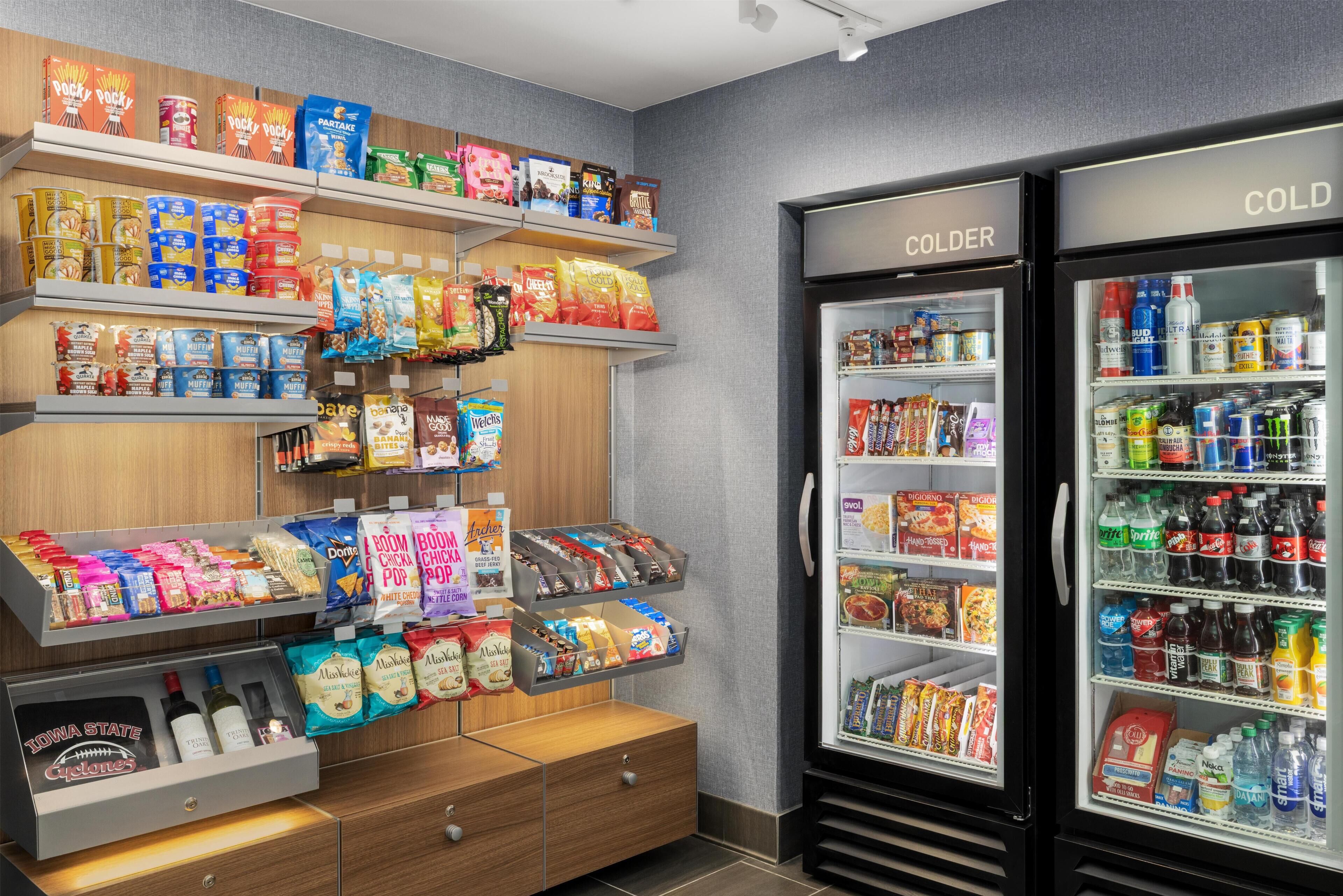 A snack display with various packaged foods and a refrigerated section with beverages.