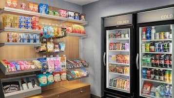 A snack display with various packaged foods and a refrigerated section with beverages.
