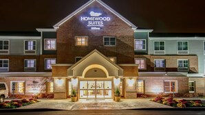 A hotel with a prominent "Homewood Suites" sign, a brick facade, and a symmetrical entrance with a central door flanked by windows. - Homewood Suites by Hilton Bridgewater/Branchburg (Branchburg)